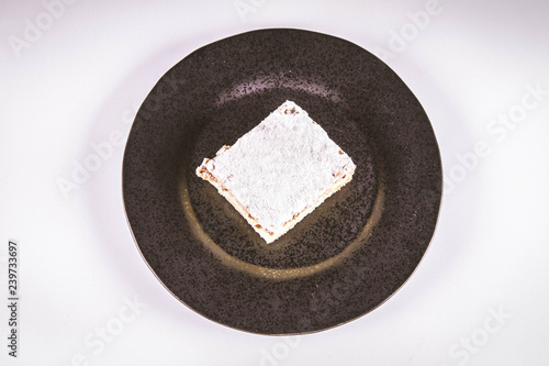 Napoleonka cake - a Polish type of cream pie - sprinkled with powdered sugar
