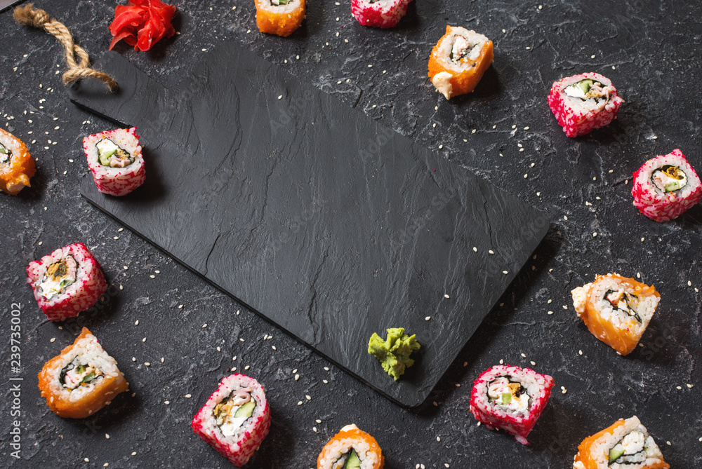 Asian or Japanese sushi set on a stone dark background. Food frame