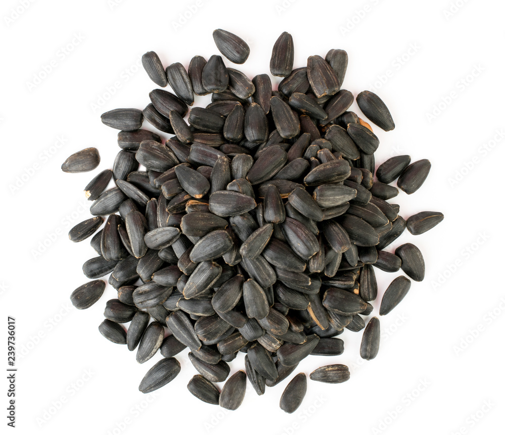 Heap sunflower seeds on a white. The view from the top. Heap sunflower seeds on a white. The view from the top.