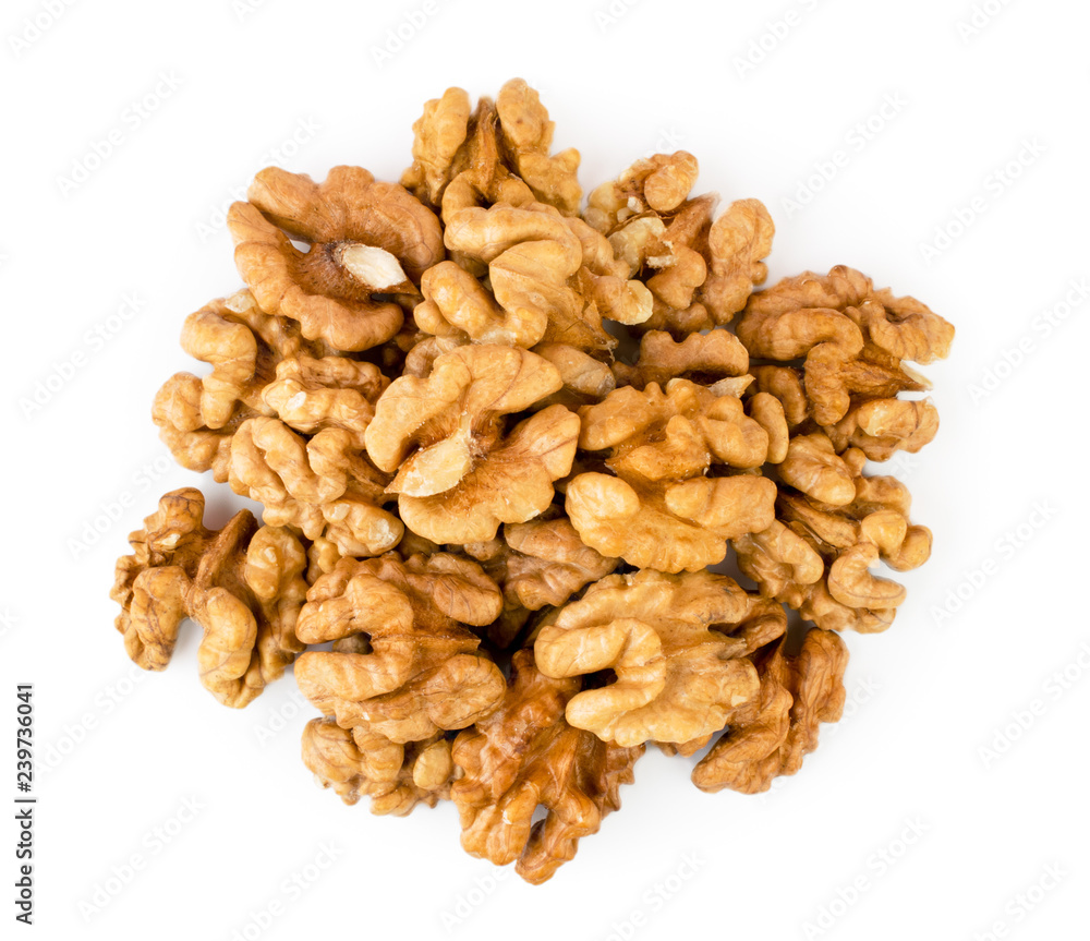 Pile of peeled walnut on a white. The view from the top. Pile of peeled walnut on a white. The view from the top.