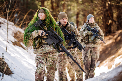 Photo team of special forces weapons in cold forest
