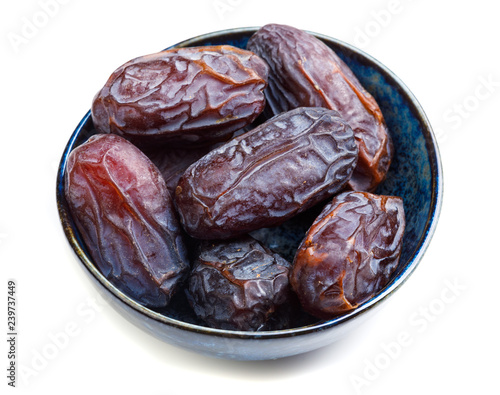 big dates in cup close-up, isolated on white background photo