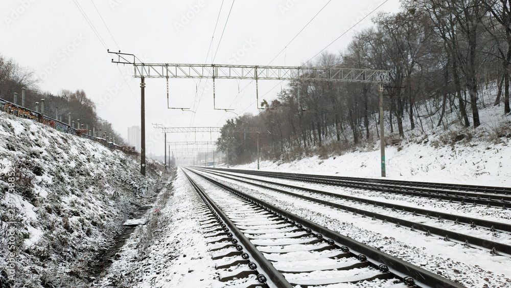 Railway tracks under the snow. Railway in winter. Empty railway track.