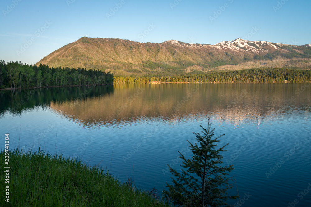 daytime mountain reflection in lakeshore