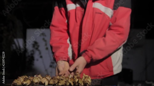 Wallpaper Mural A man prepares meat outdoors in the winter. Torontodigital.ca