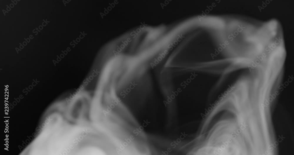 Smoke background. White smoke floating through space against black background Smoke background. White smoke floating through space against black background