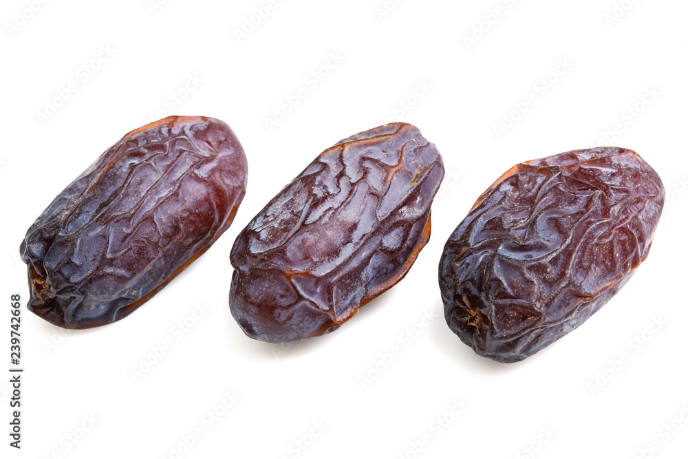 three peaces single big dates close-up with wrinkled skin surface isolated on white background three peaces single big dates close-up with wrinkled skin surface isolated on white background