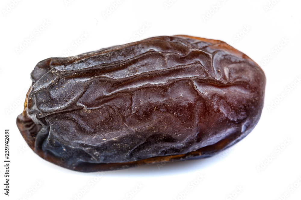 single big dates close-up with wrinkled skin surface single big dates close-up with wrinkled skin surface