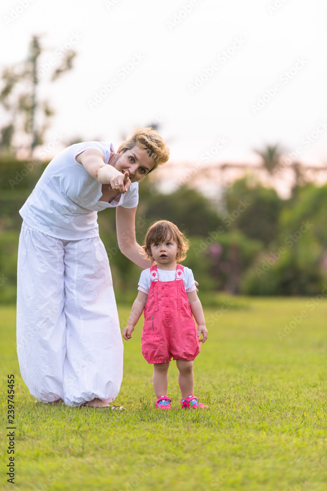 mother and little daughter playing at backyard mother and little daughter playing at backyard