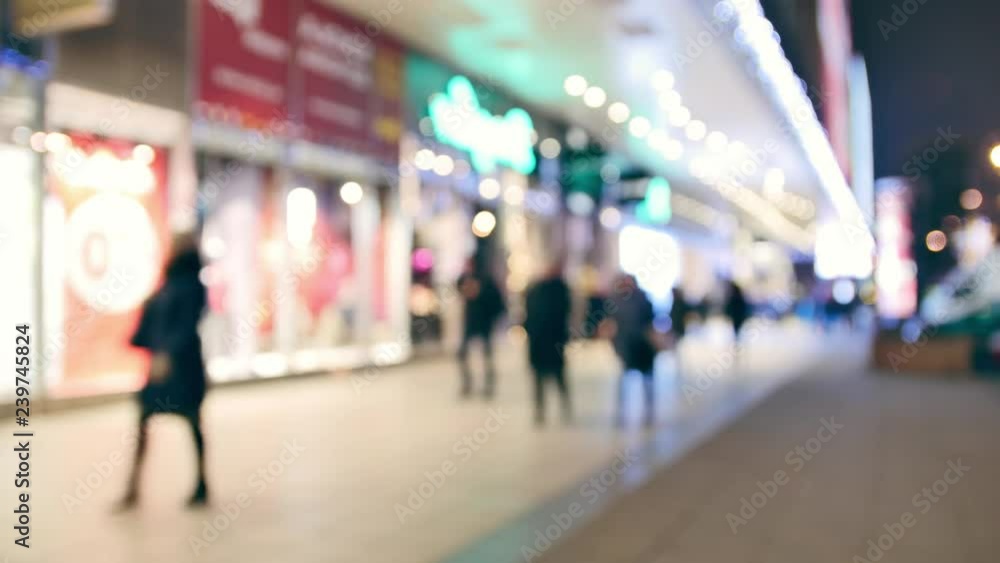 Unrecognizable people walking on the street. Very bright, out of focus scene. Unrecognizable people walking on the street. Very bright, out of focus scene.