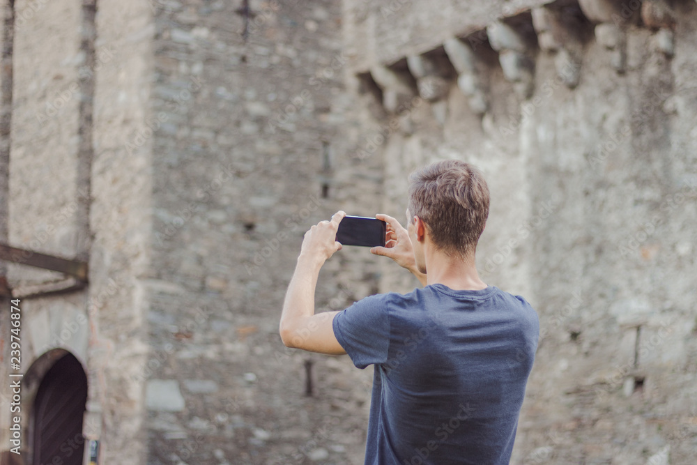 Young man is taking a picture of a castle