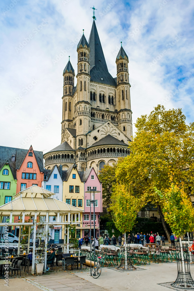 Naklejka premium COLOGNE - NOVEMBER 07, 2018 : Colorful houses in front of St. Martin's church on november 07, 2018 in Cologne