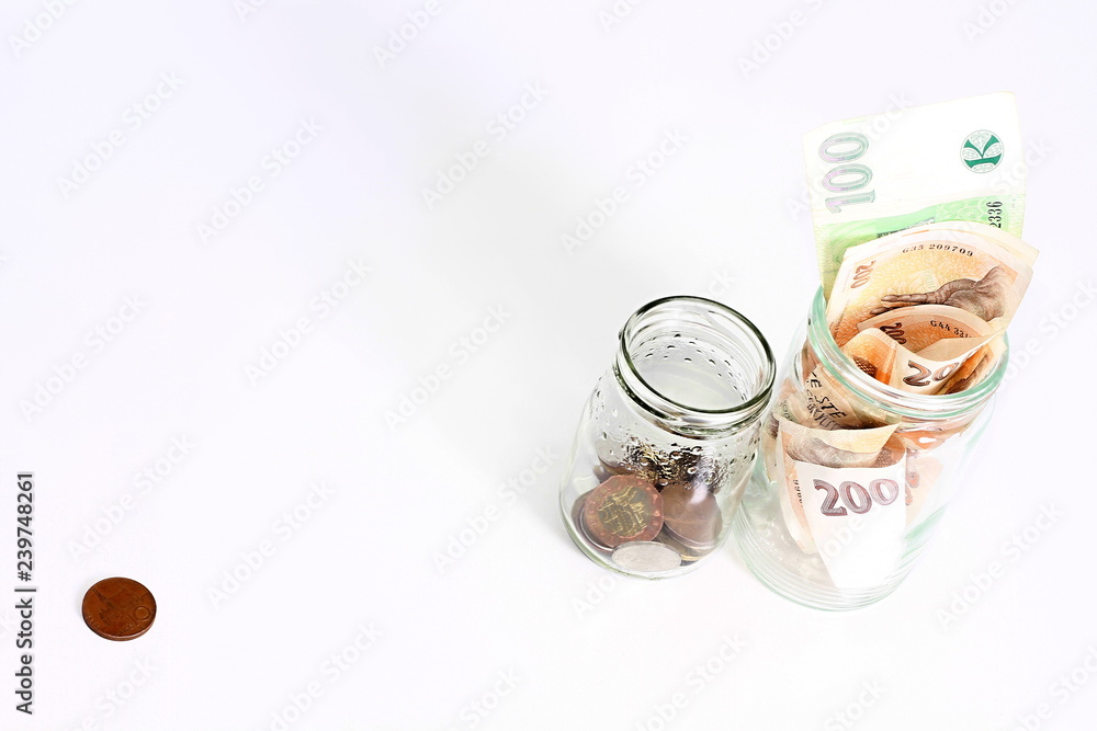 glass jars with coins and banknotes glass jars with coins and banknotes