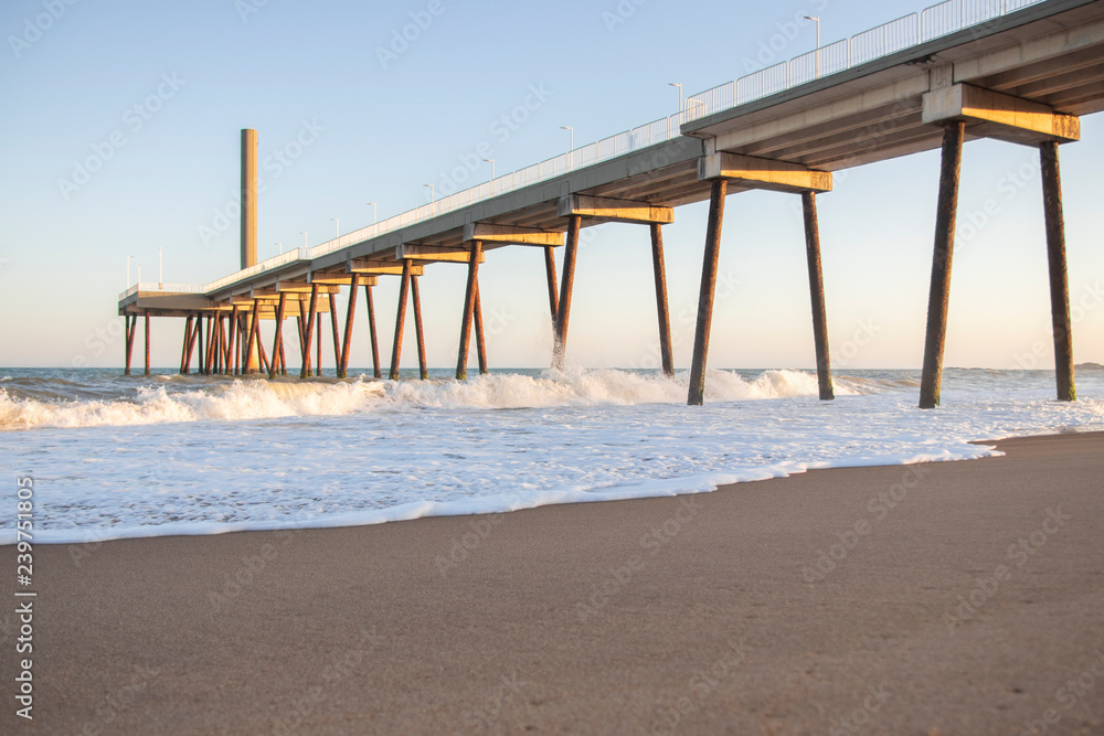 pier on the beach with waves and blue sky (costa azul, rio das ostras, rio de janeiro, brazil) pier on the beach with waves and blue sky (costa azul, rio das ostras, rio de janeiro, brazil)