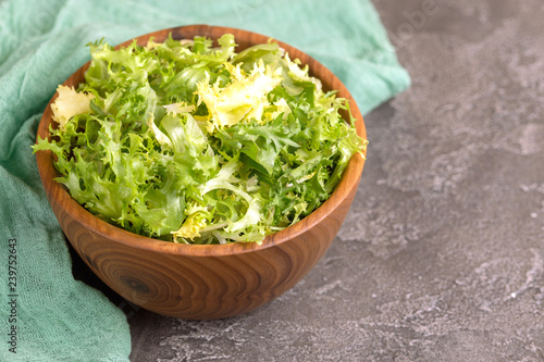 Konstfotografi Fresh frisee salad in wooden bowl. Healthy food