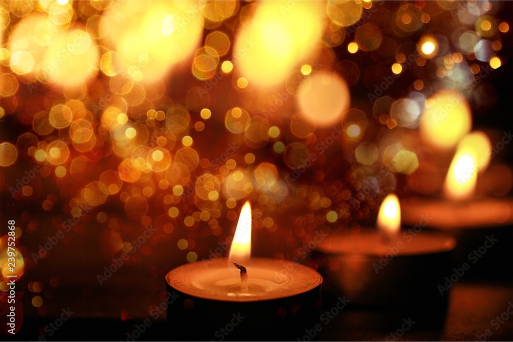 Close up view of the candles cutting through the darkness. Close up view of the candles cutting through the darkness.