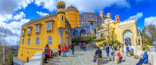 Tourists in front of the main entrace in Pena Palace visiting the most famous historic landmark architecture of Sintra village in Portugal photo