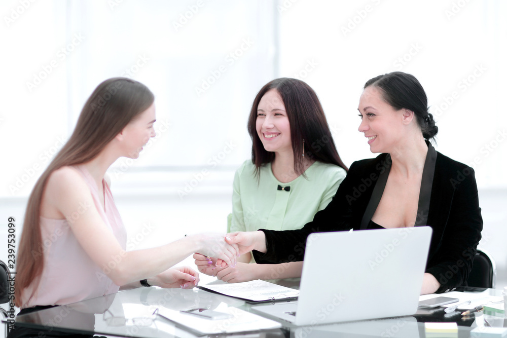 handshake of business partners at your Desk.woman and business handshake of business partners at your Desk.woman and business