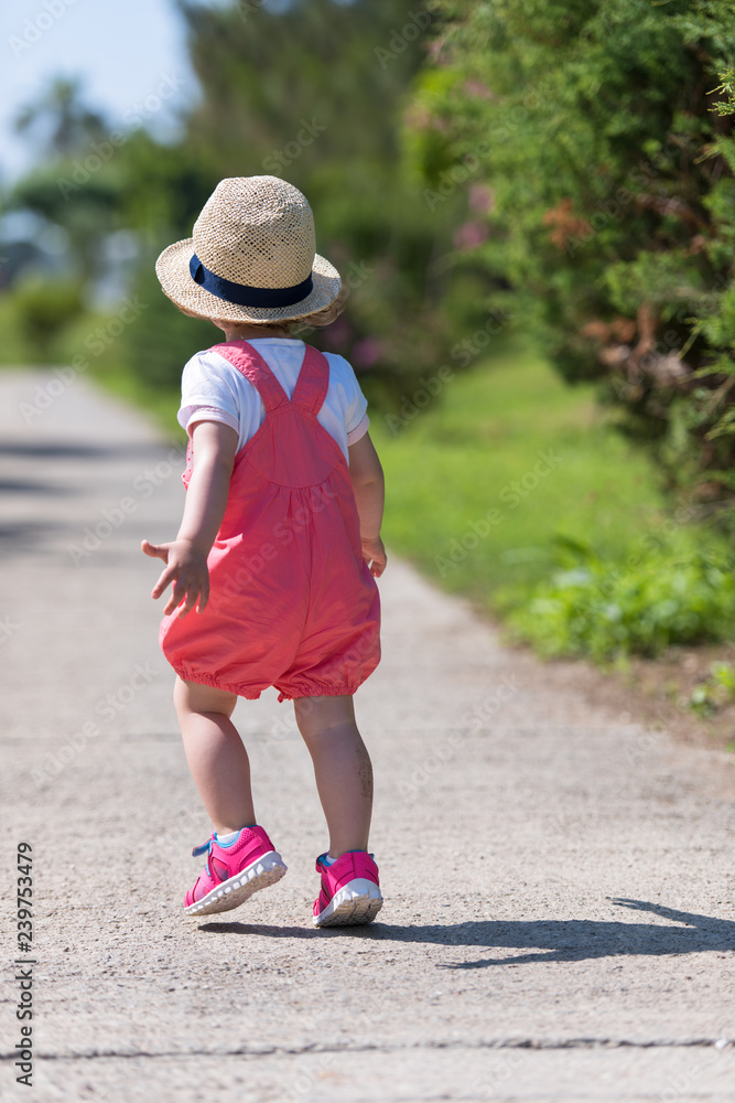 Fototapeta premium little girl runing in the summer Park