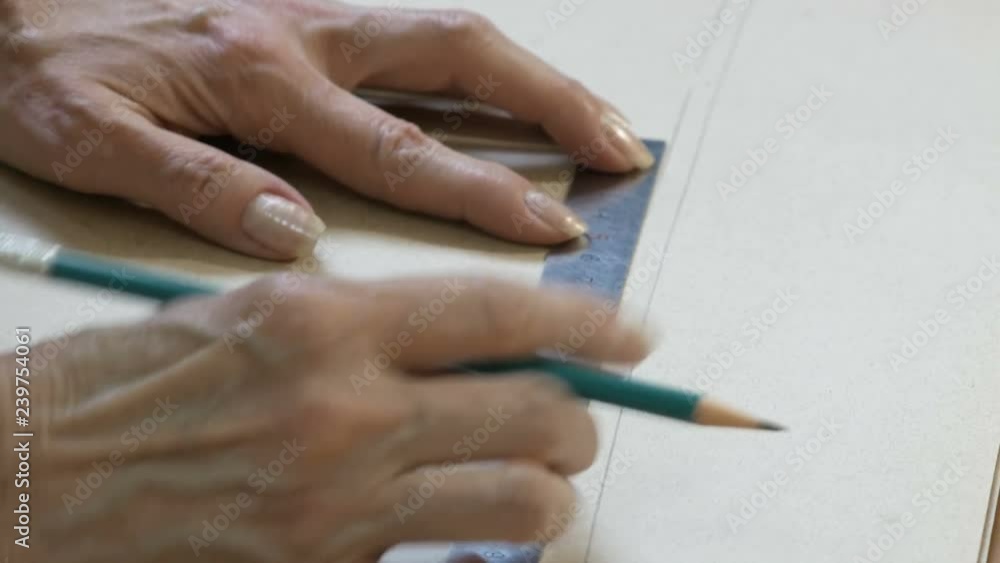 Seamstress ruler and pencil in hand is making drawings for clothes. Style and design development and creating garment, clothes sew and repair service, tailor concept Seamstress ruler and pencil in hand is making drawings for clothes. Style and design development and creating garment, clothes sew and repair service, tailor concept