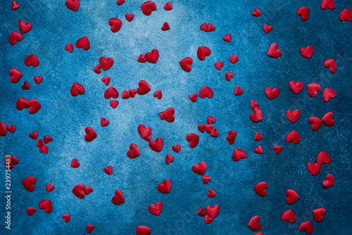 Valentines Day background. Red hearts on dark blue background. Copy space, top view. © Laima Gri