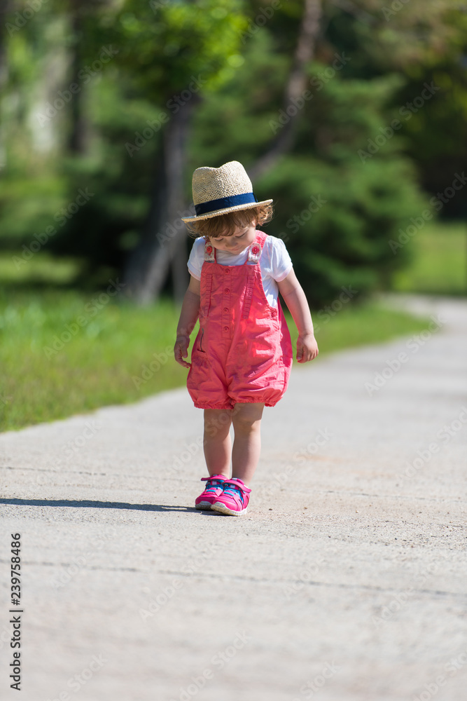 little girl runing in the summer Park