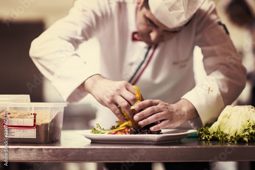 chef serving vegetable salad