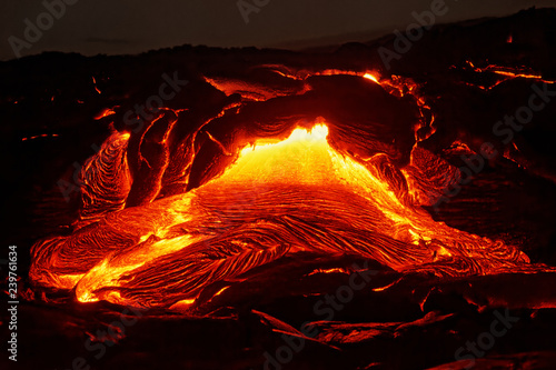 Detailed view of an active lava flow, hot magma emerges from a crack in the earth, the glowing lava appears in strong yellows and reds - Location: Hawaii, Big Island, volcano 
