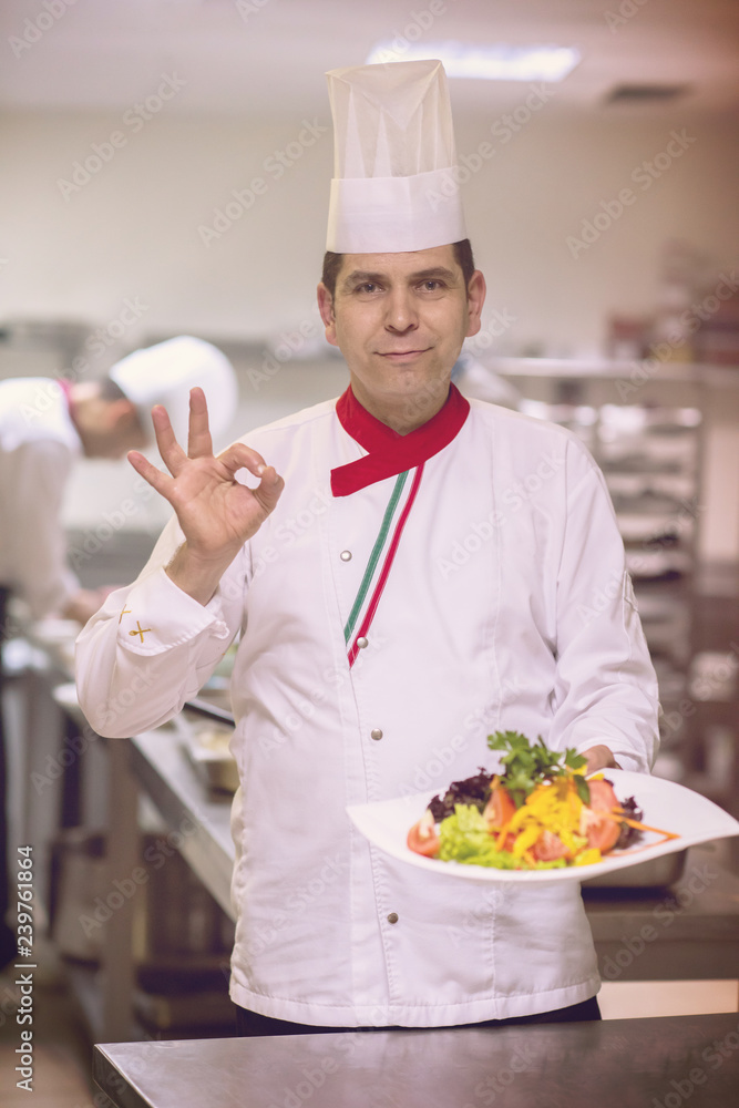 Chef showing a plate of tasty meal Chef showing a plate of tasty meal