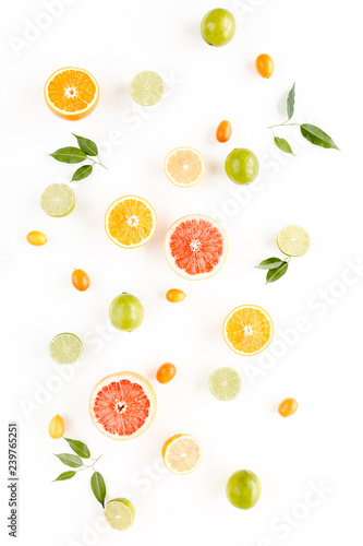 Creative background made of summer tropical fruits: grapefruit, orange, lemon, lime and leaves ficus. Food concept. flat lay, top view
