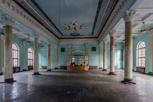 Interior of large column hall with fretwork at abandoned mansion © Mulderphoto