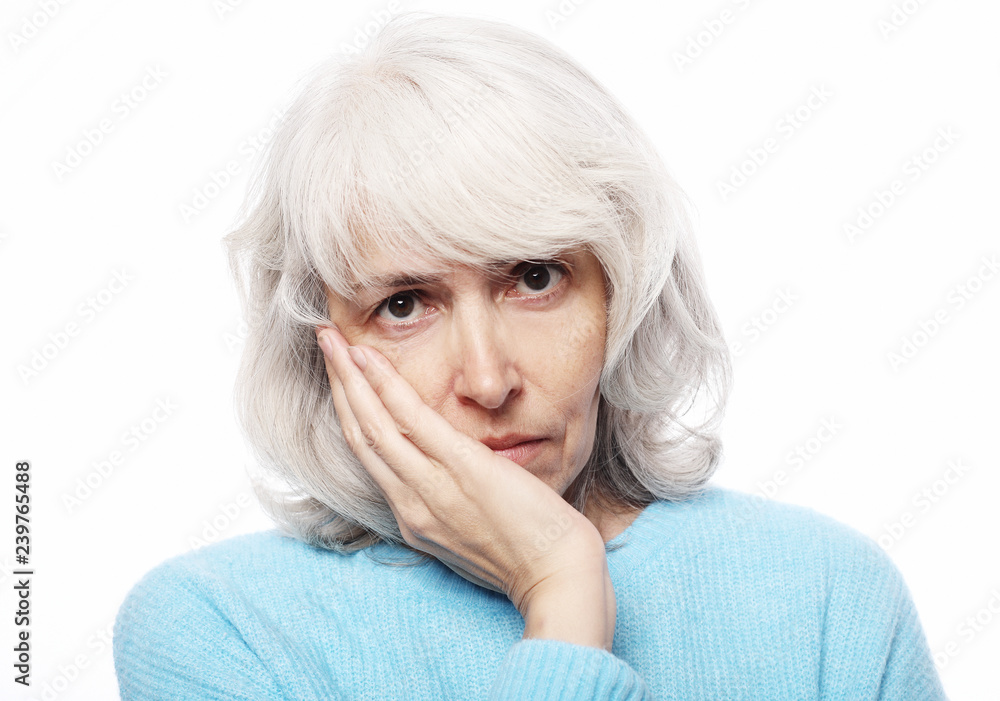 Lifestyle, health and people concept: Elderly woman suffering from toothache on white background Lifestyle, health and people concept: Elderly woman suffering from toothache on white background