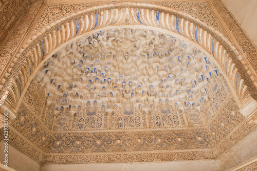 Closeup of a beautiful medieval time architecture seen inside Alhambra Palace. The architecture seems apalling and stunning with details. The design is similarly fascinating. photo