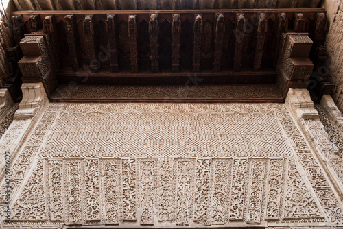 Closeup of a beautiful medieval time architecture seen inside Alhambra Palace. The architecture seems apalling and stunning with details. The design is similarly fascinating. photo