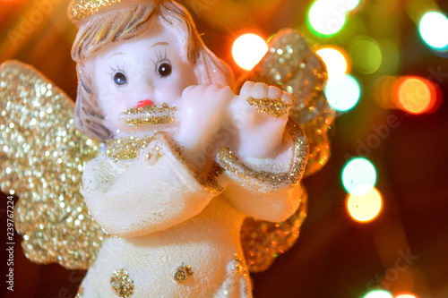 Angel with gold wings on background of bokeh lights. Christmas, New Year picture