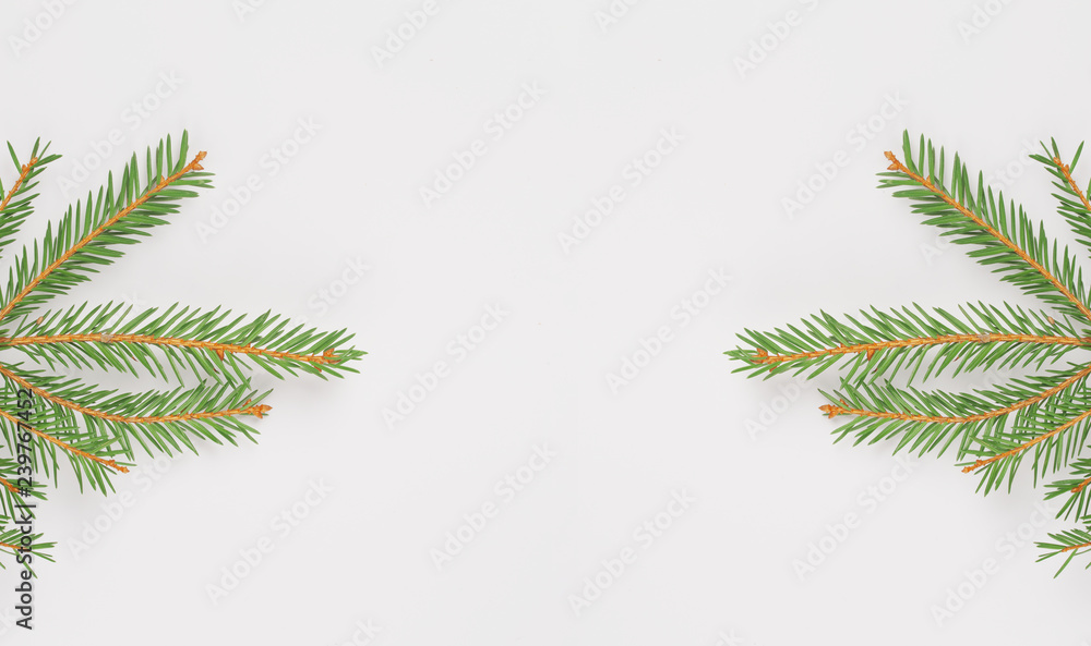 Christmas composition. Creative layout made with fir spruce green branches isolated on white background. Christmas tree branch. Flat lay, top view, copy space. Pastel colors, trendy minimal concept.
