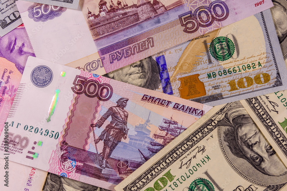 Obraz premium Background of the different american and russian banknotes