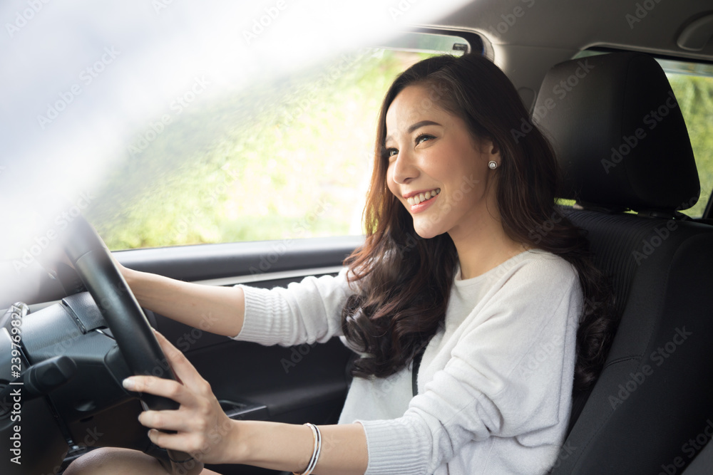 Asian women driving a car and smile happily with glad positive expression during the drive to travel journey, People enjoy laughing transport and relaxed happy woman on roadtrip vacation concept