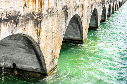 View under Old Seven Mile Knights Key-Pigeon Key-Moser Channel-Pacet Channel Bridge near overseas highway road, ocean, sea waves, green water at Pigeon key, Florida photo