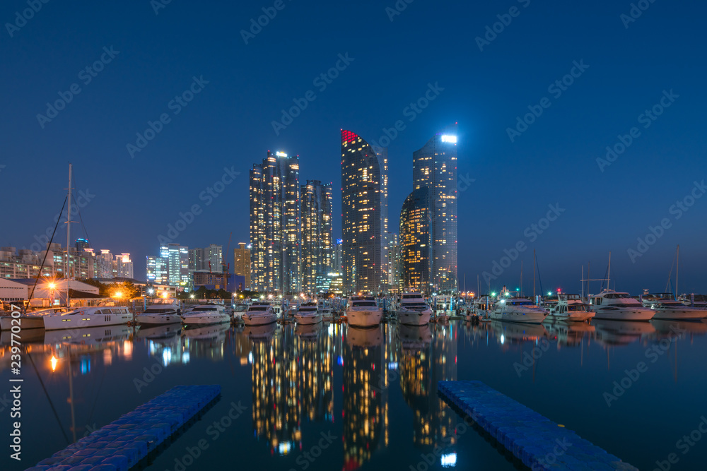 Busan city skyline view at Haeundae district, Gwangalli Beach with yacht pier at Busan, South Korea.