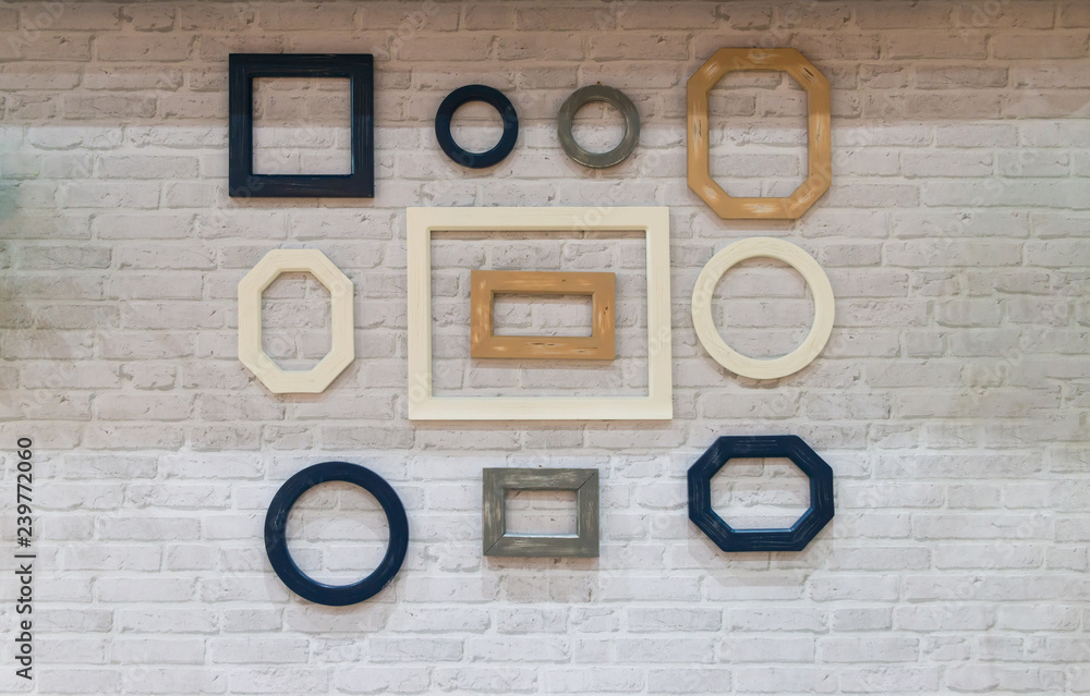 Beautiful of wooden frame, various shapes on a white brick wall Beautiful of wooden frame, various shapes on a white brick wall