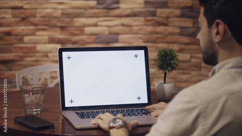 Business man working in modern office cafeteria. Latin businessman with pc at corporate job. Busy hispanic manager with laptop computer at work. Screen and monitor for technology, internet and website