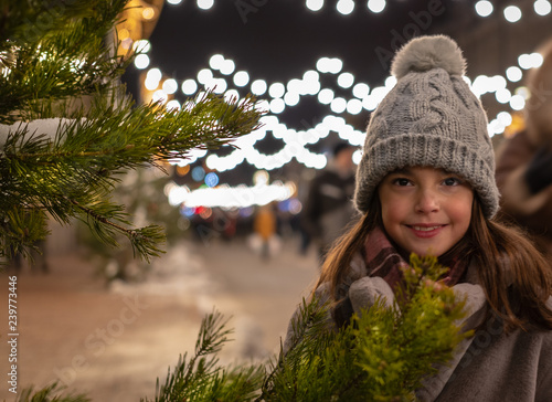 background. beautiful girl walks in a festively decorated winter city. Christmas, New Year, Saint Nicholas, Santa.
