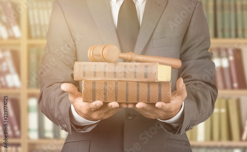 Business man in grey suit holding books