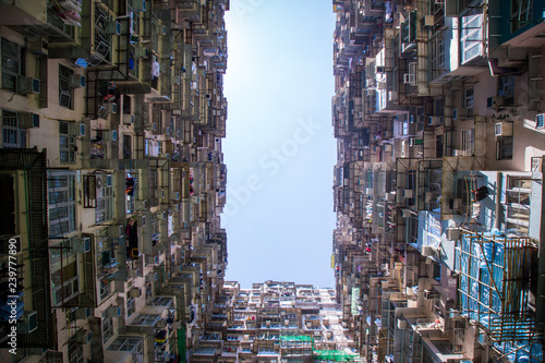 Famous building name Yick Fat Yick residentrial building at Cheong Fok Cheong in Quarry Bay, Hong Kong with urban housing apartment background. photo