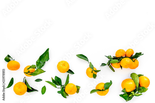 Fototapeta Naklejka Na Ścianę i Meble -  Winter fruits for New Year and Christmas. Tangerines on white background top view mock-up