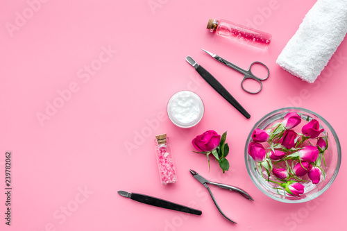 manicure tools set for nail care on rose background top view mock up photo