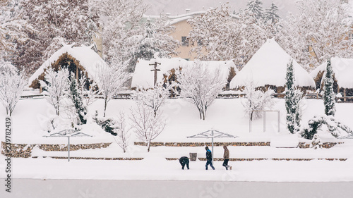 people running in snow - winter landscape with old houses © Seid