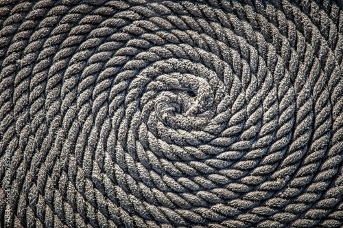 The rope for the boat laid in the form of a spiral. Background.
