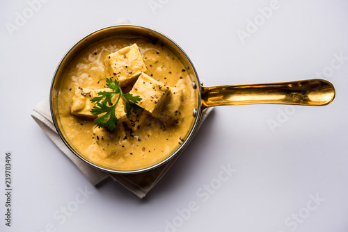 Malai or achari Paneer in a gravy made using Whipping Cream. served on a serving pan. selective focus